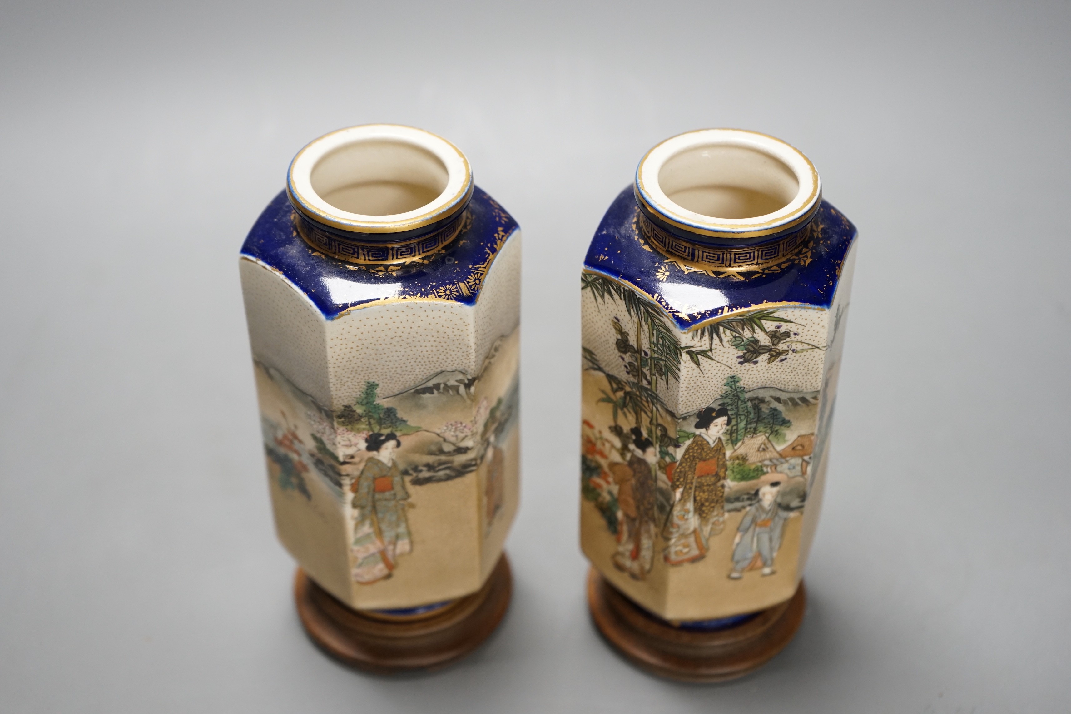 A pair of Japanese Satsuma pottery hexagonal vases, Meiji period, on stands 16cm